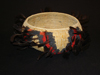 A Chukchansi bowl with yarn and feathers